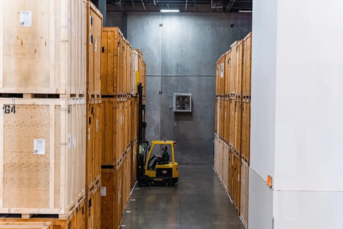 Forklift moves storage boxes at an All My Sons storage facility.